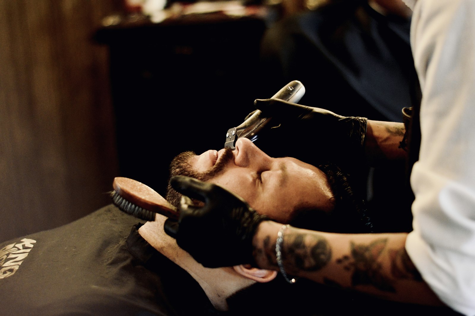 Barber Ray Kovac giving a hot-towel straight-razor shave