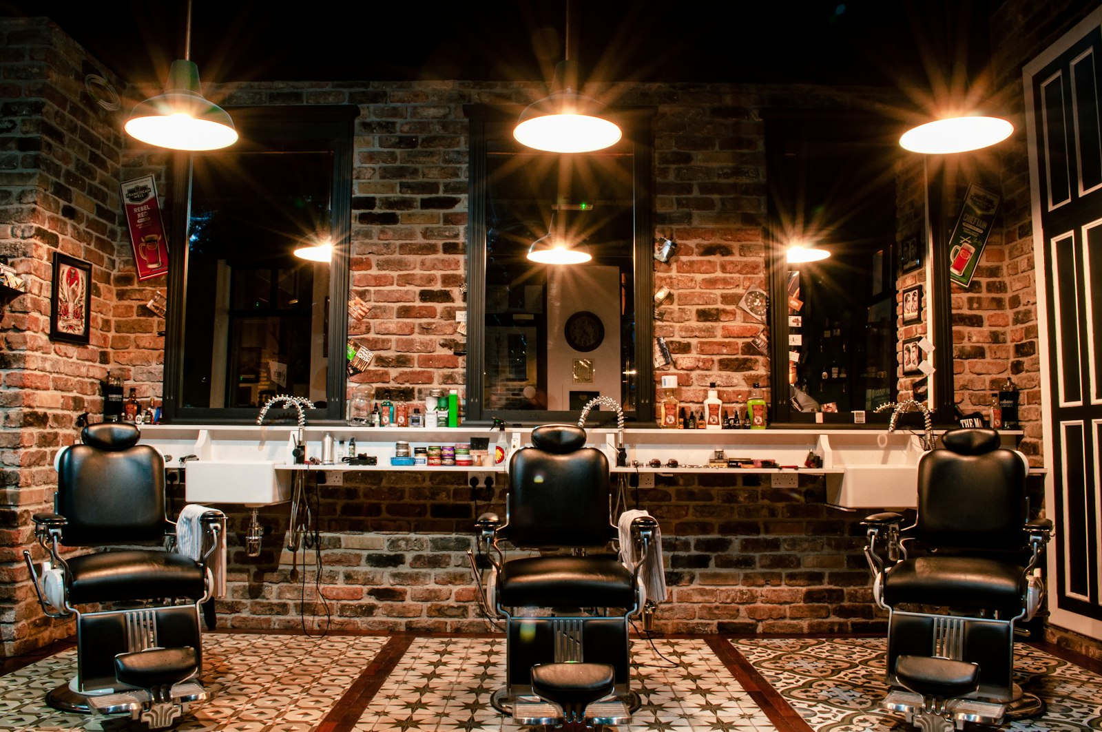 Fadehouse shop interior with three vintage leather barber chairs and brick walls