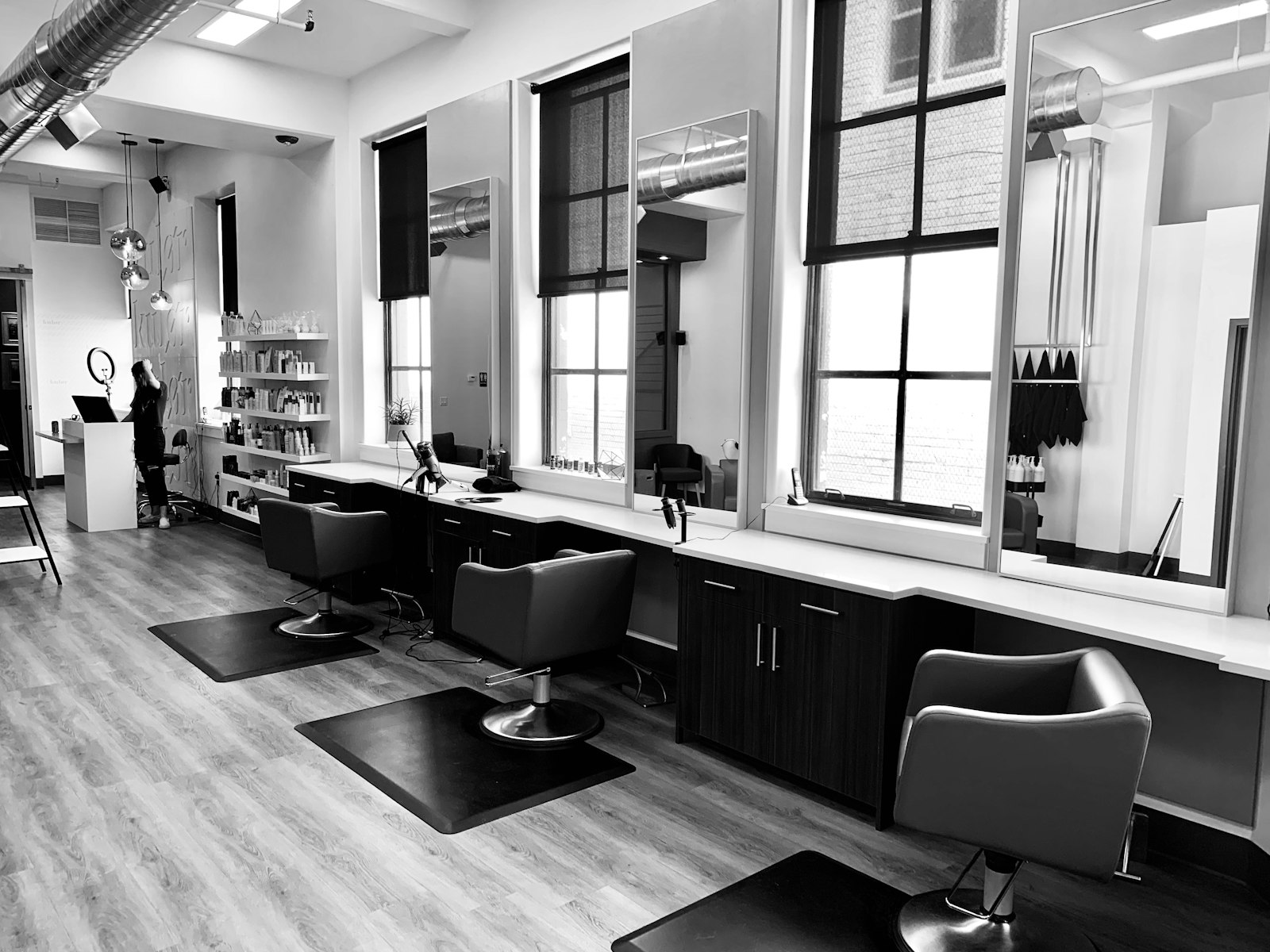 The Fadehouse shop floor on Larchmere Boulevard — barber chairs, mirrors and stations along the window wall