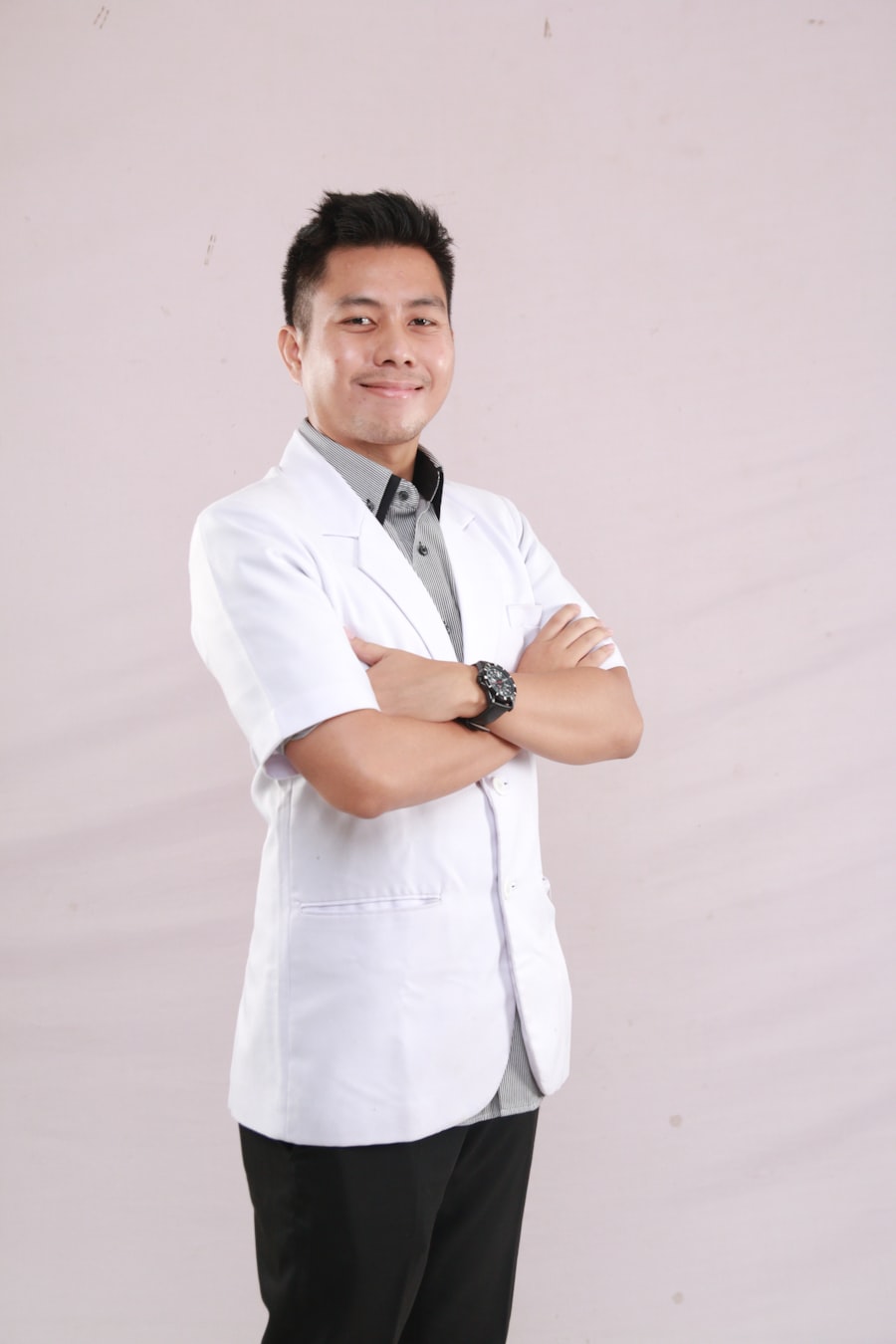 Marco Silva, lead dental hygienist, smiling in his white clinic coat