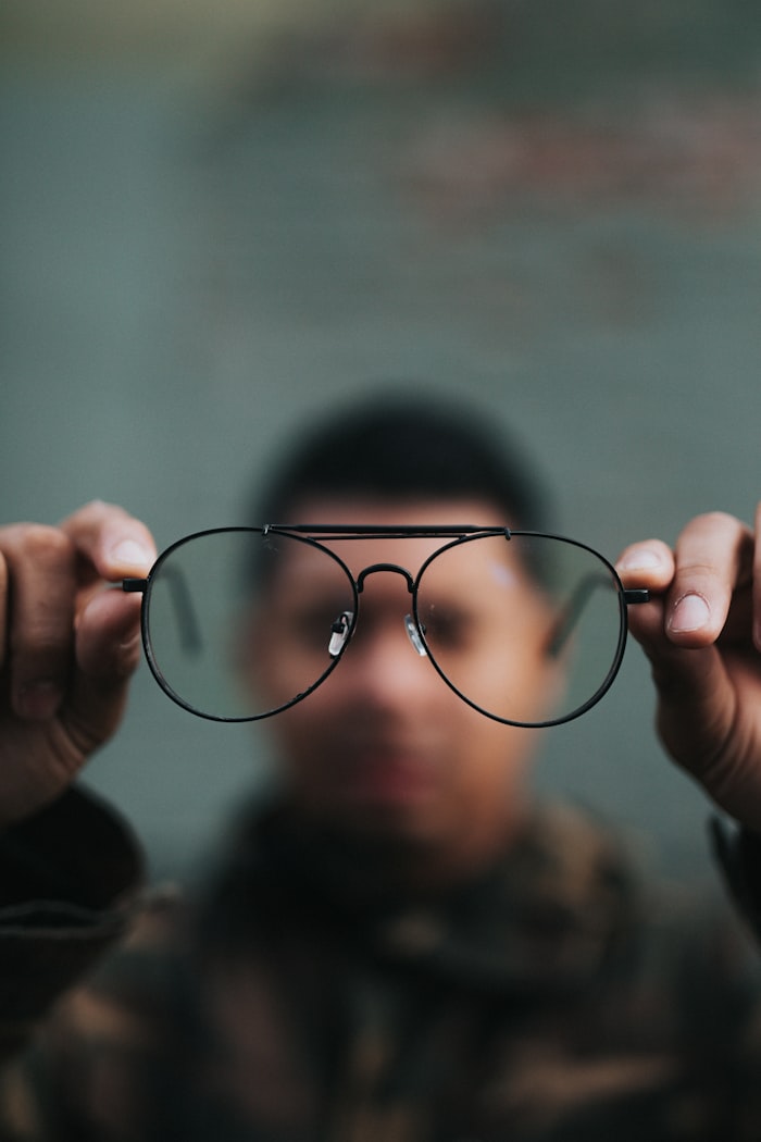 Lunet Corvair aviator frames in matte black metal, held up to the light