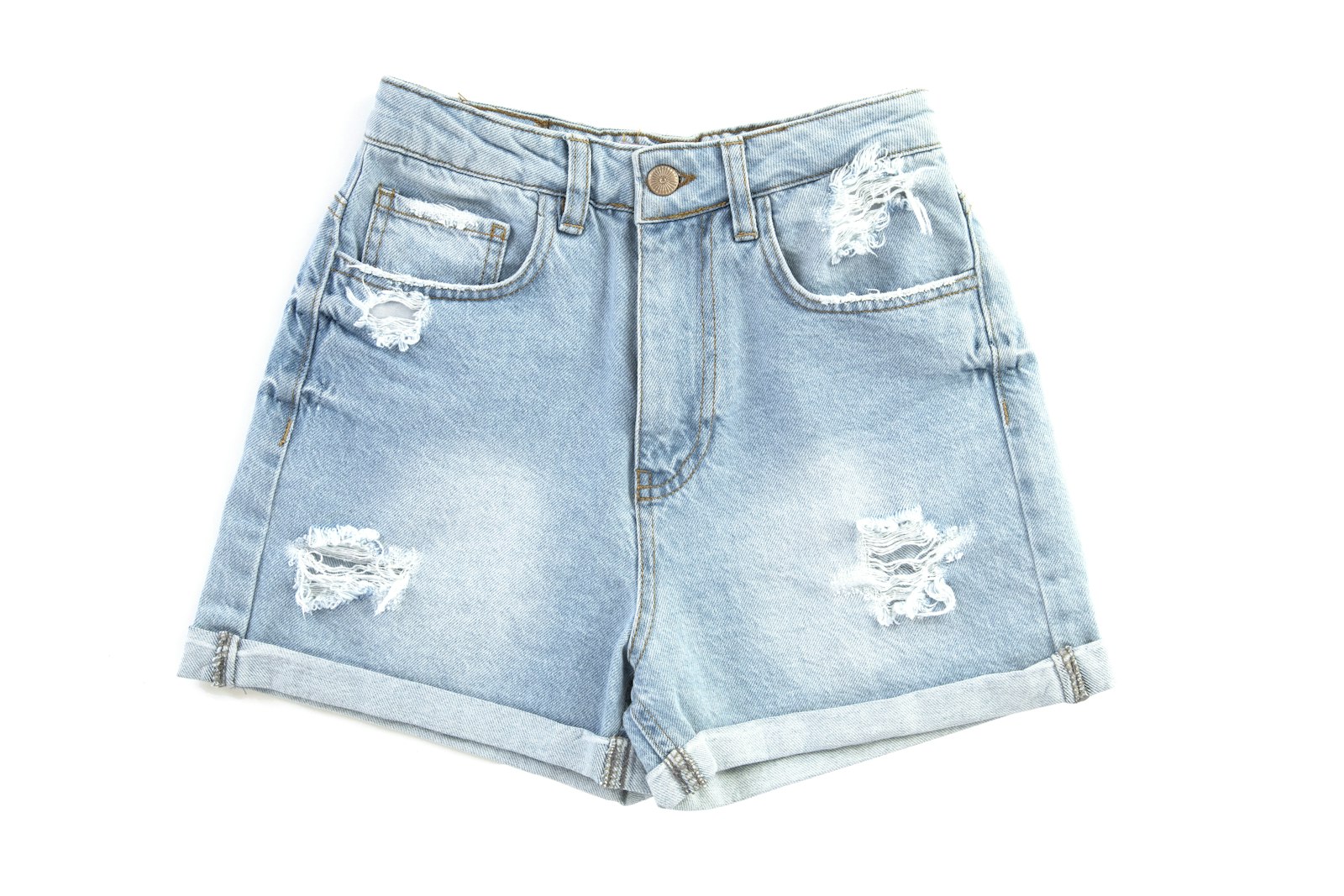 Pair of distressed light-wash denim shorts laid flat on white