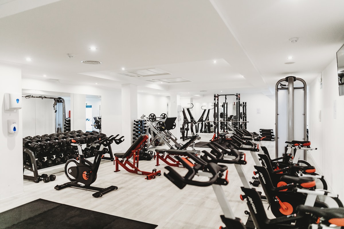 Dark-toned free weights area with racks and platforms