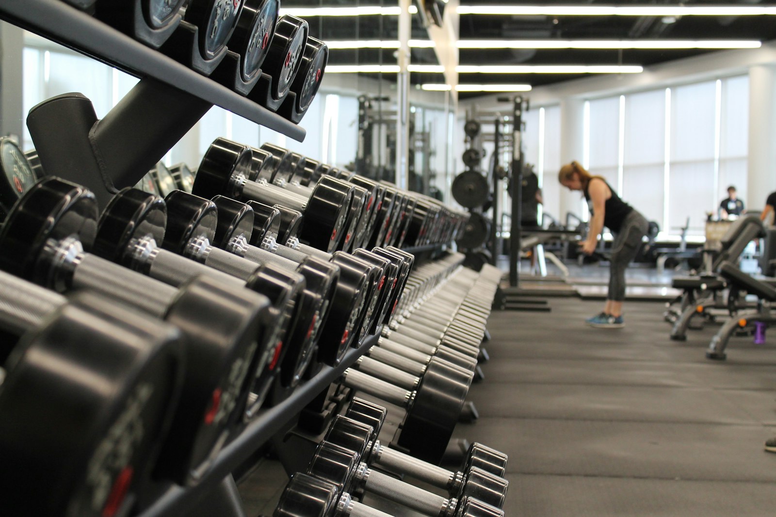 Racked dumbbells along the FORMA training floor