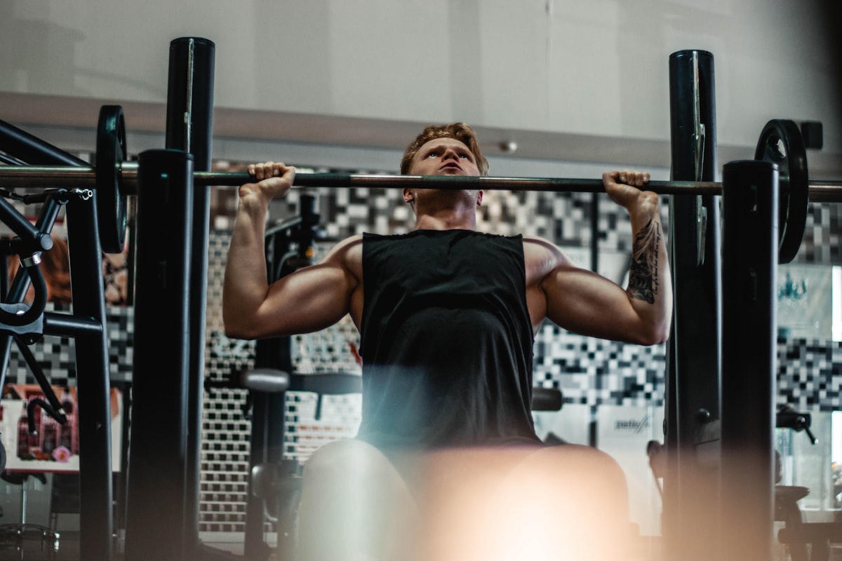 Coach Ryder Nakamura pressing at a rack on the open-gym floor
