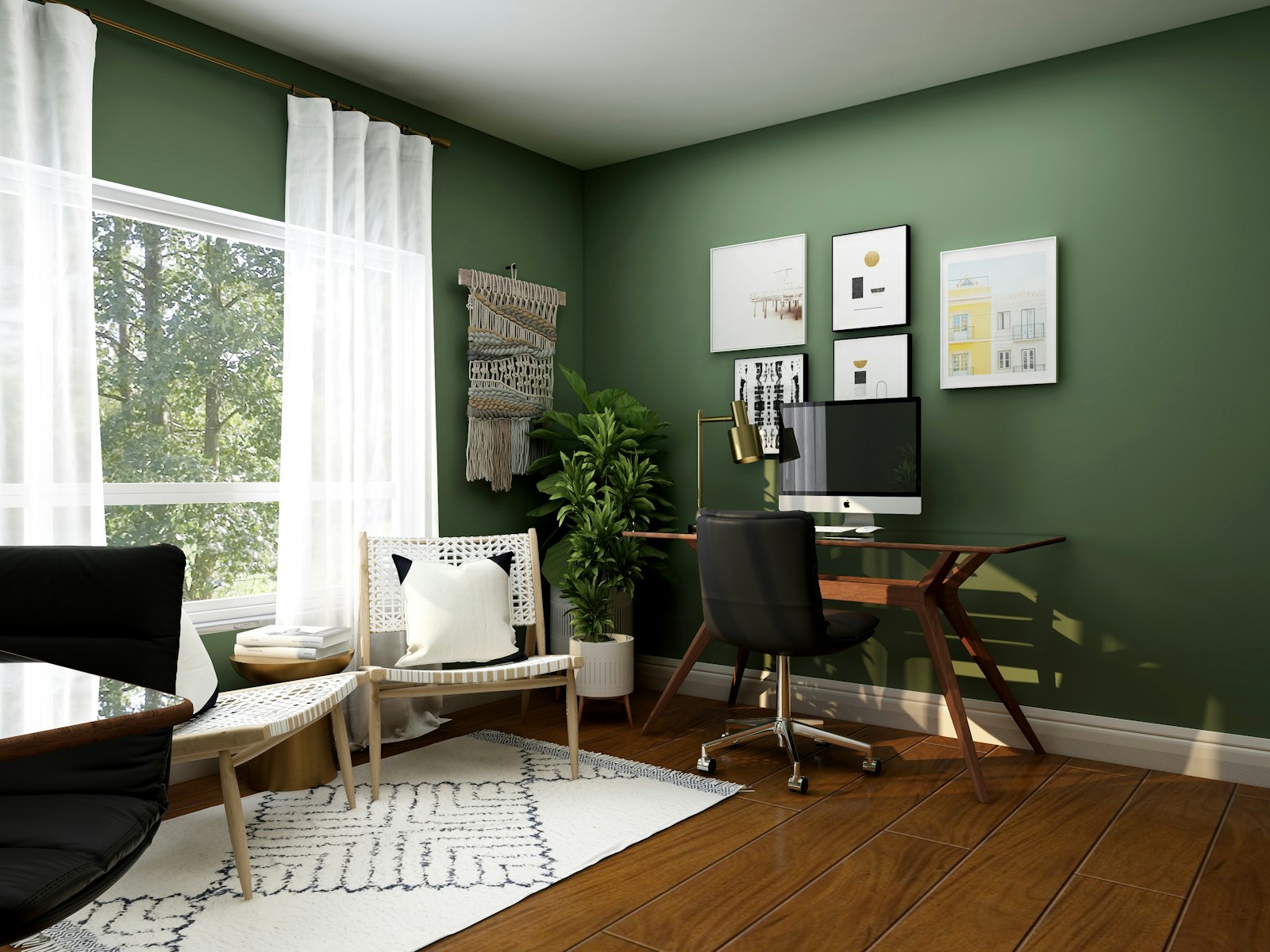 Study corner with a walnut writing desk, woven lounge chair and bench against a deep green wall
