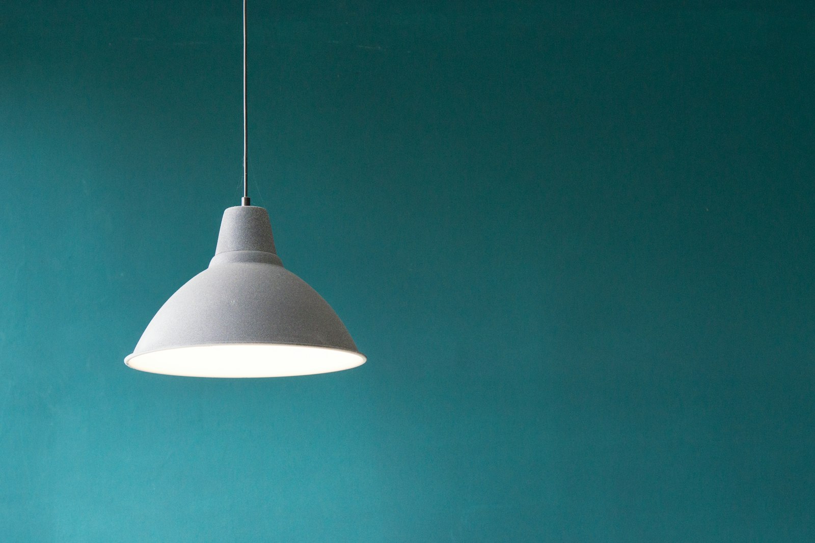 Grey enamelled dome pendant lamp hanging on a slim cord