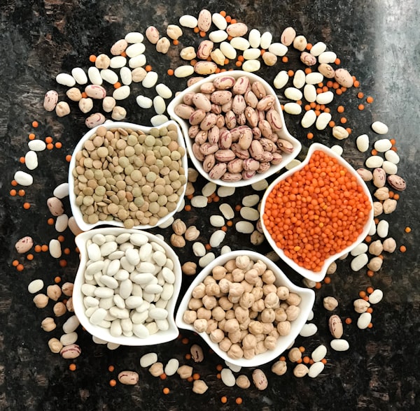 Bowls of green lentils, borlotti beans, red split lentils, butter beans and chickpeas