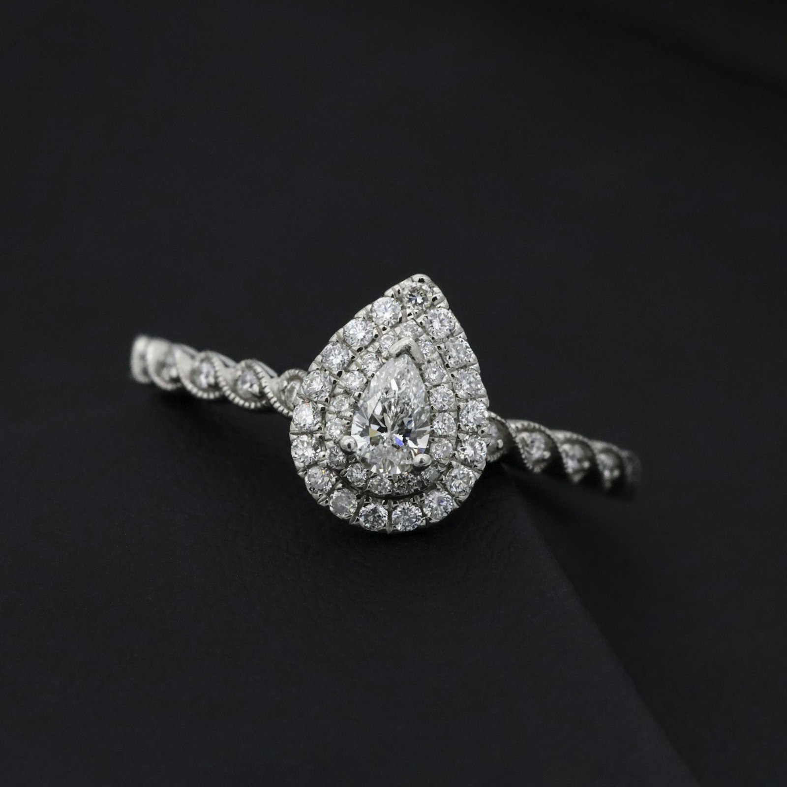 The Solenne pear-cut diamond ring in 18k white gold, photographed on black