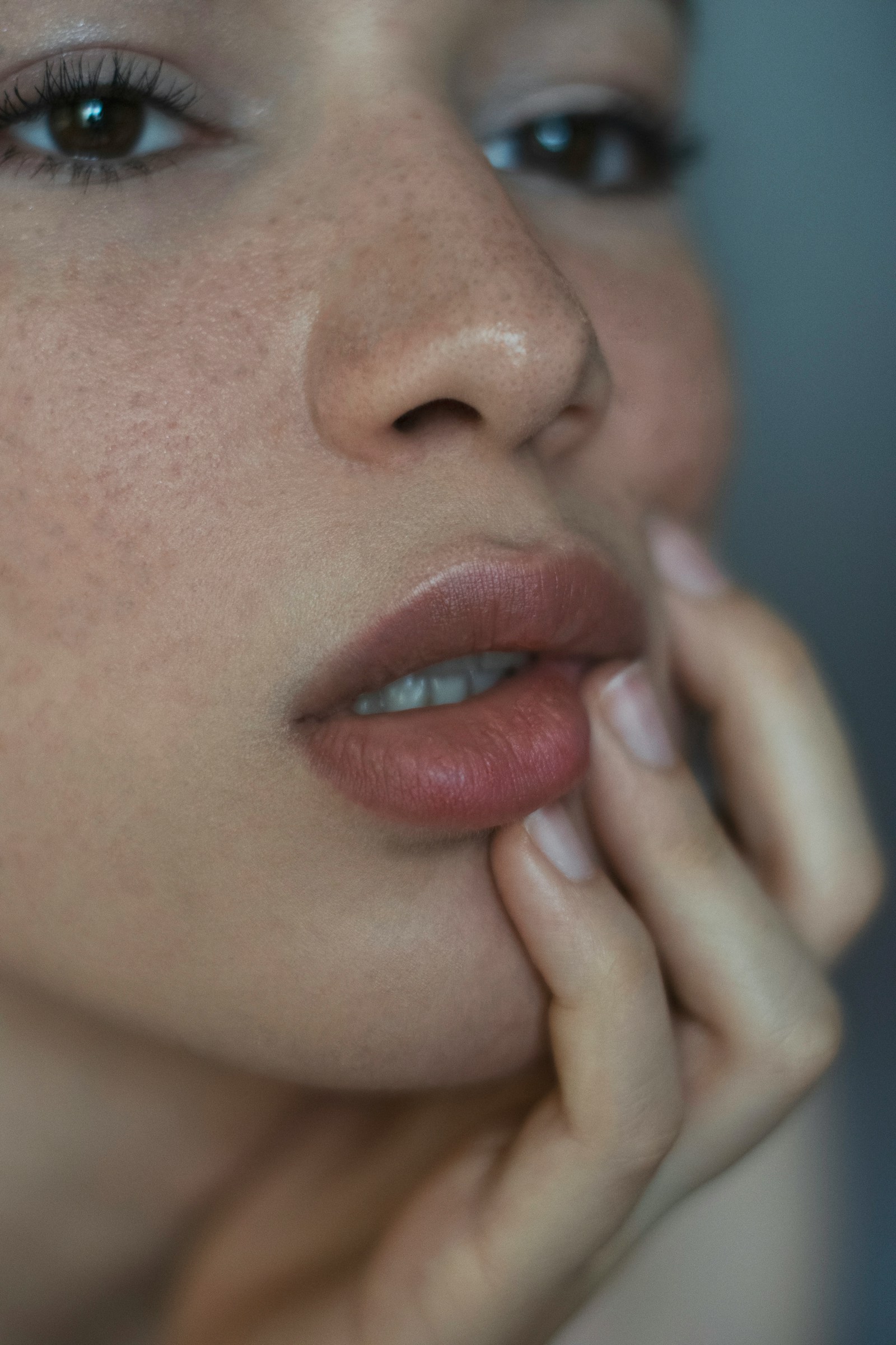 Case four, before state: close crop of a face resting on a hand, shown in a cooler grade.