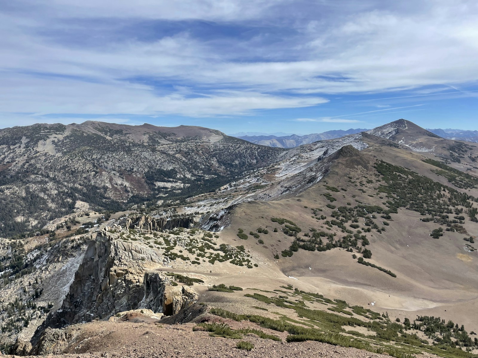 Wide granite basin in the Eastern Sierra with a bare summit ridge and scattered pines