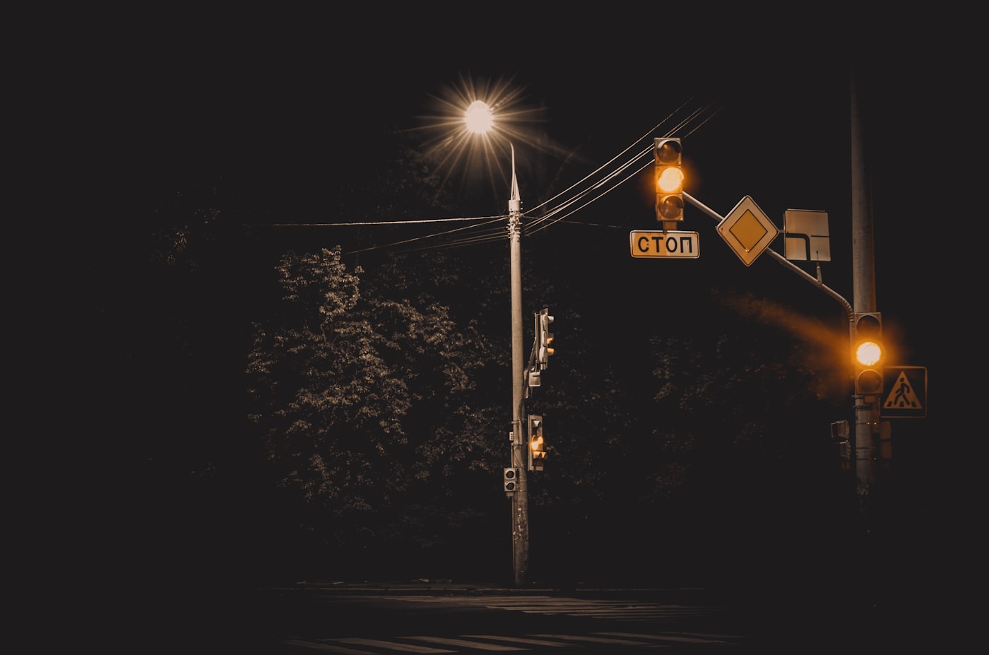Sodium series cover — amber traffic signals and a street lamp burning against a black night