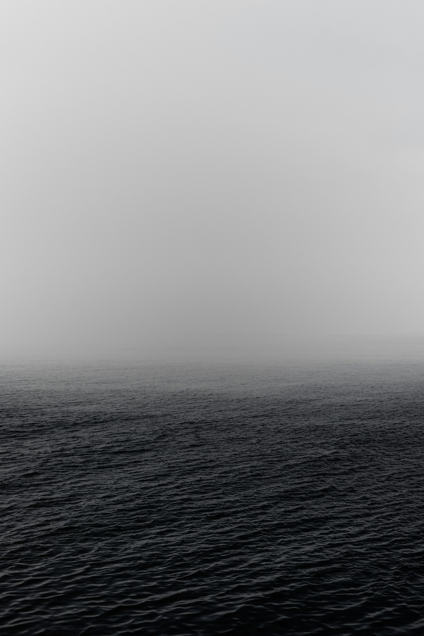 Cold Static series cover — dark open water dissolving into flat grey sea fog