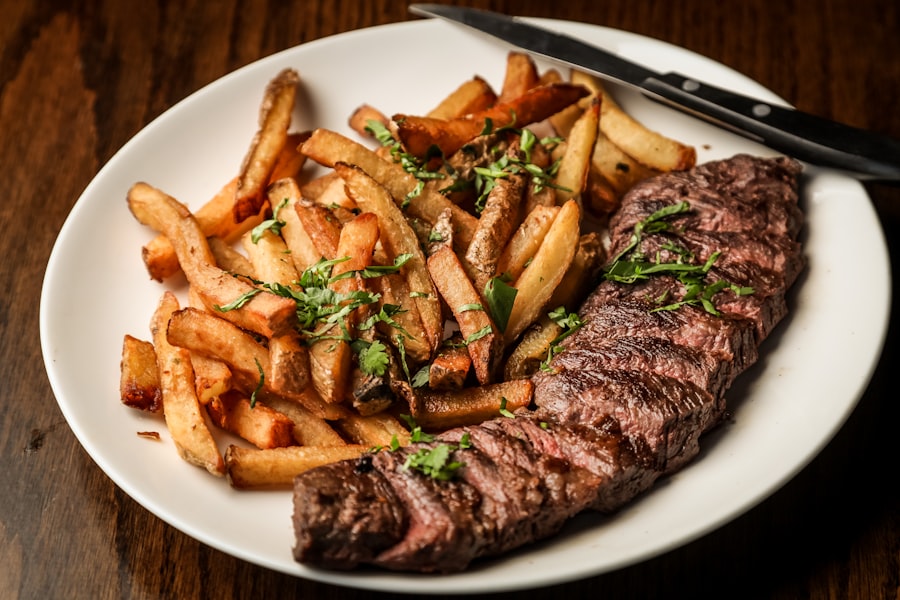 Grilled steak with roasted vegetables plated at the pass